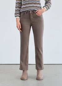 Front view of taupe straight-leg mid-rise jeans styled with ankle boots