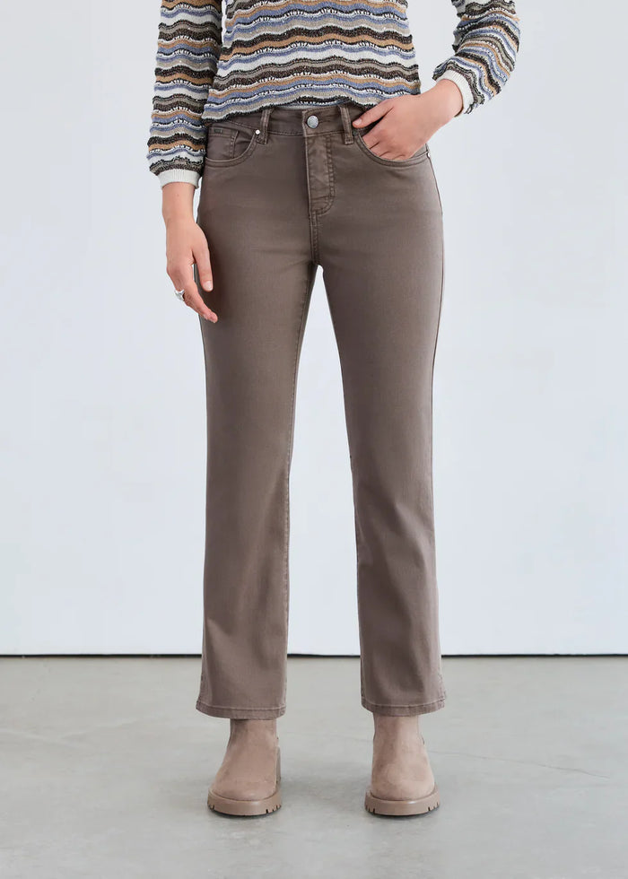 Front view of taupe straight-leg mid-rise jeans styled with ankle boots