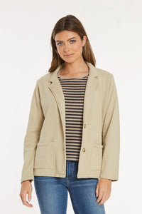 Woman wearing beige knit blazer over striped top, front view