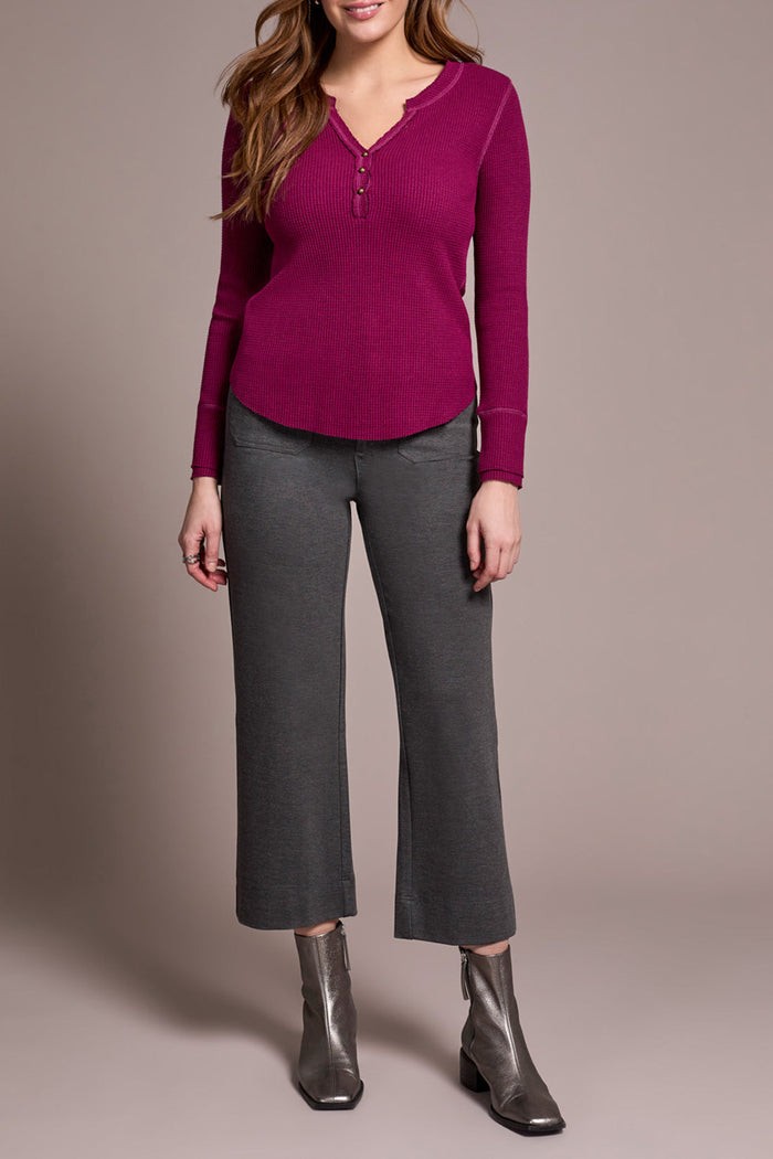 Straight-on view of heather charcoal crop pants styled with long-sleeve top and boots