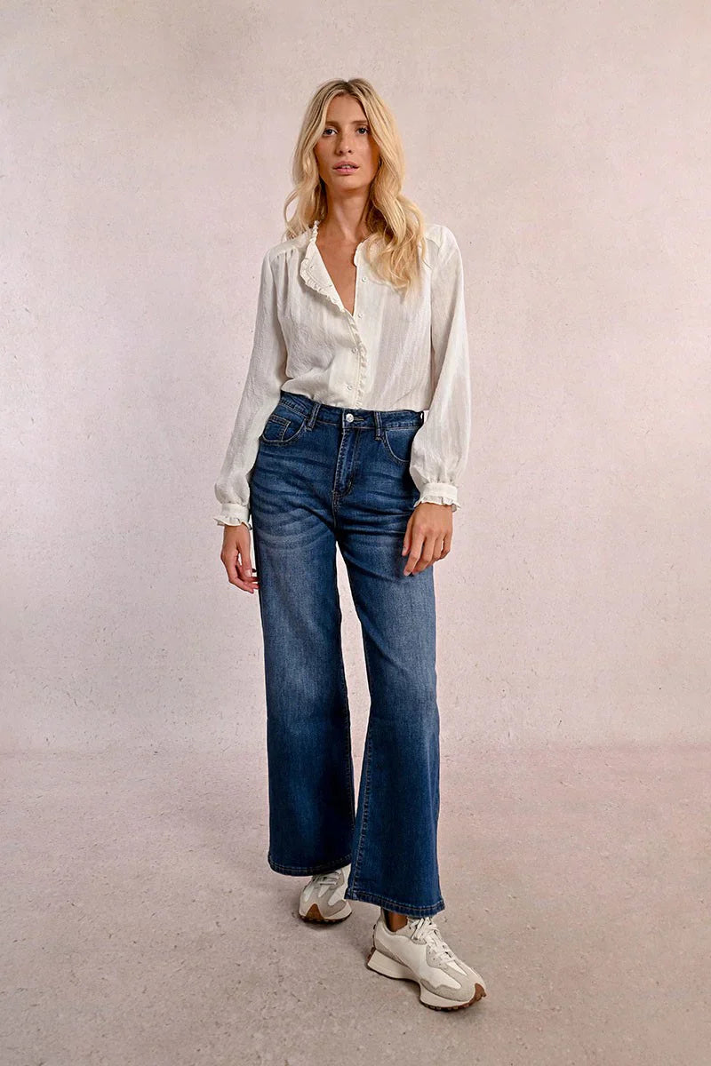 Full-length photo of a woman modeling Molly Bracken wide leg blue jeans