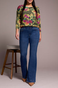 Full body front view of woman modeling classic flare stretch blue jeans