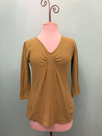 Front view of golden mustard 3/4 sleeve V-neck top with ruched detail