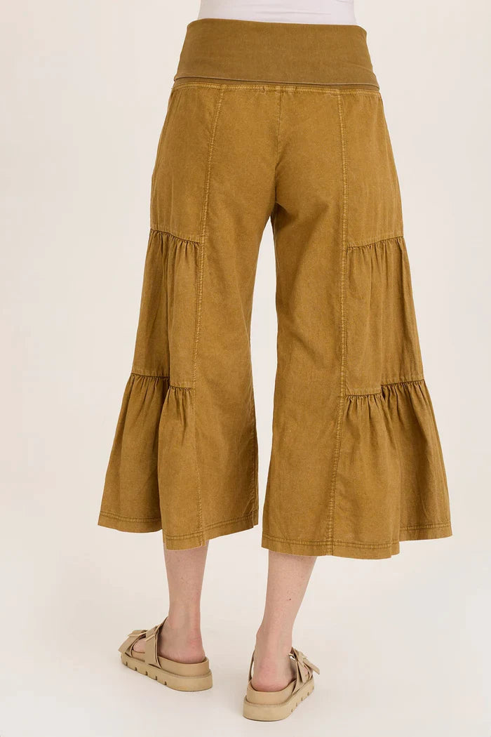 Back view of golden tiered wide leg pants with a comfy waistband