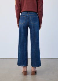 Close-up of high-rise wide leg jeans from the front with visible seam details