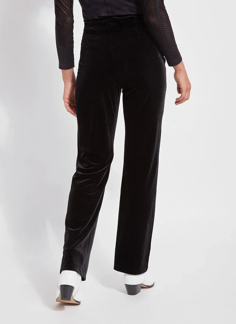 Back view displaying the fit of high-waisted black velvet trousers