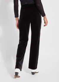 Back view displaying the fit of high-waisted black velvet trousers