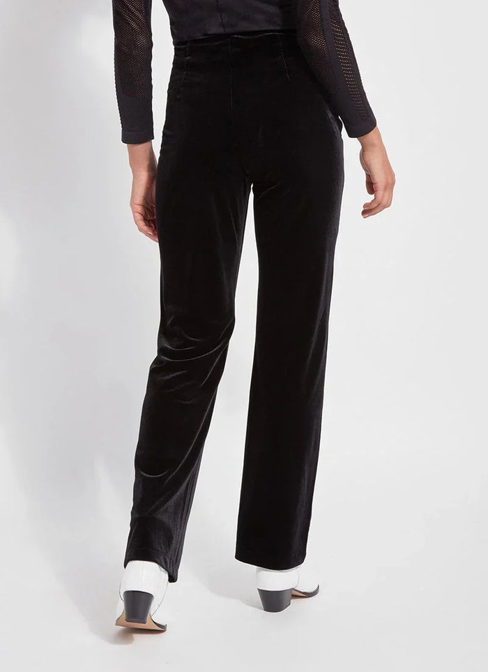 Back view displaying the fit of high-waisted black velvet trousers