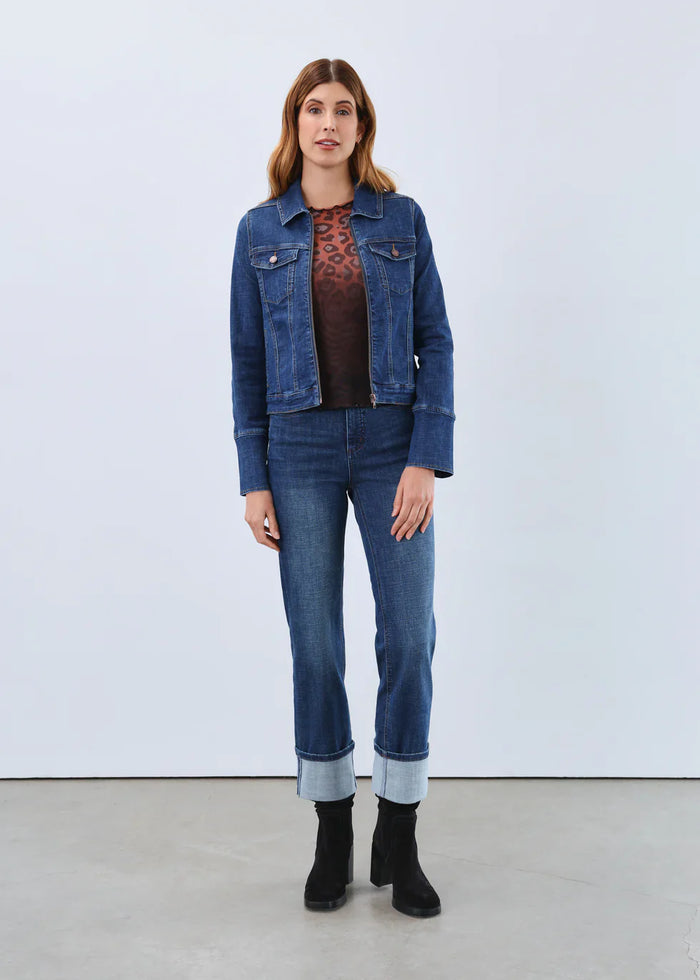 Woman wearing high-waisted straight leg jeans with large cuffed hems and denim jacket