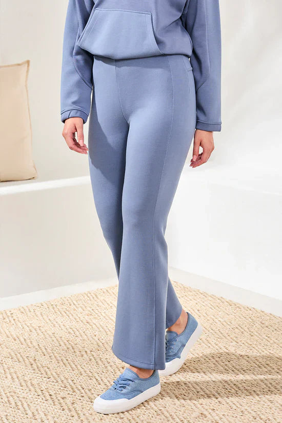 Close-up of lavender flared lounge pants paired with matching sneakers