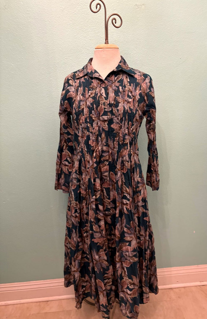 Full front view of long sleeve, pleated midi dress with autumn leaf pattern