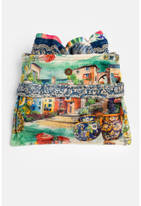 Folded travel blanket with Mediterranean village and floral print