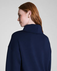 Back view showing mock neck collar and relaxed fit of navy sweatshirt