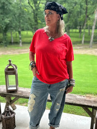 Woman outdoors wearing a Wild Gypsy red pocket t-shirt with distressed jeans and accessories