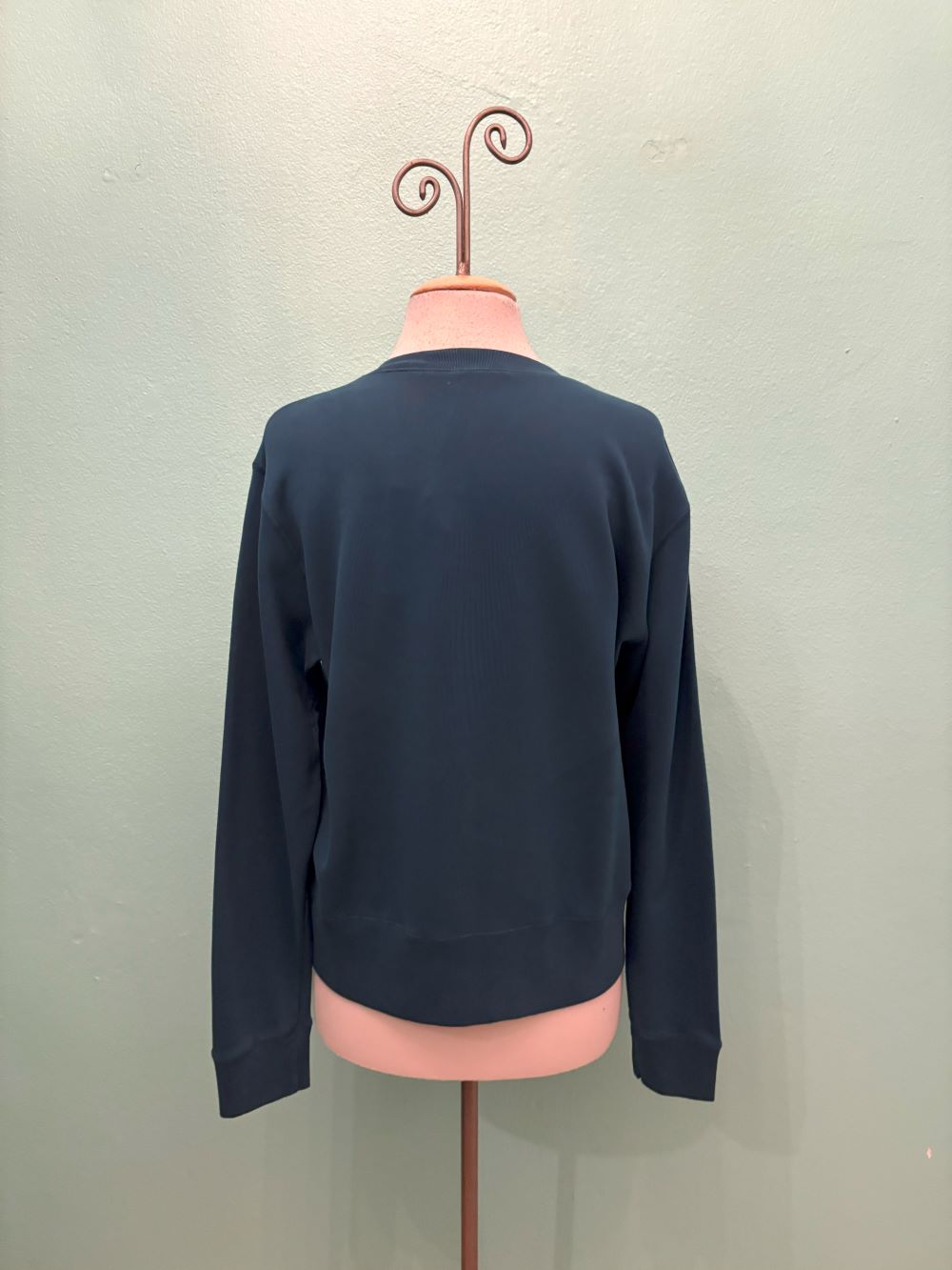 Back view of navy V-neck pullover on mannequin