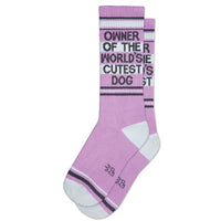 Pair of pink socks with 'Owner of the World's Cutest Dog' text on white stripes
