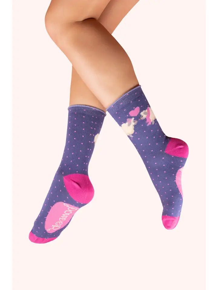 Purple crew socks with pink polka dots, pony and heart design, and contrasting pink heels and toes