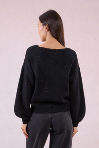 Back view of black V-neck sweater showing loose fit and sparkle accents