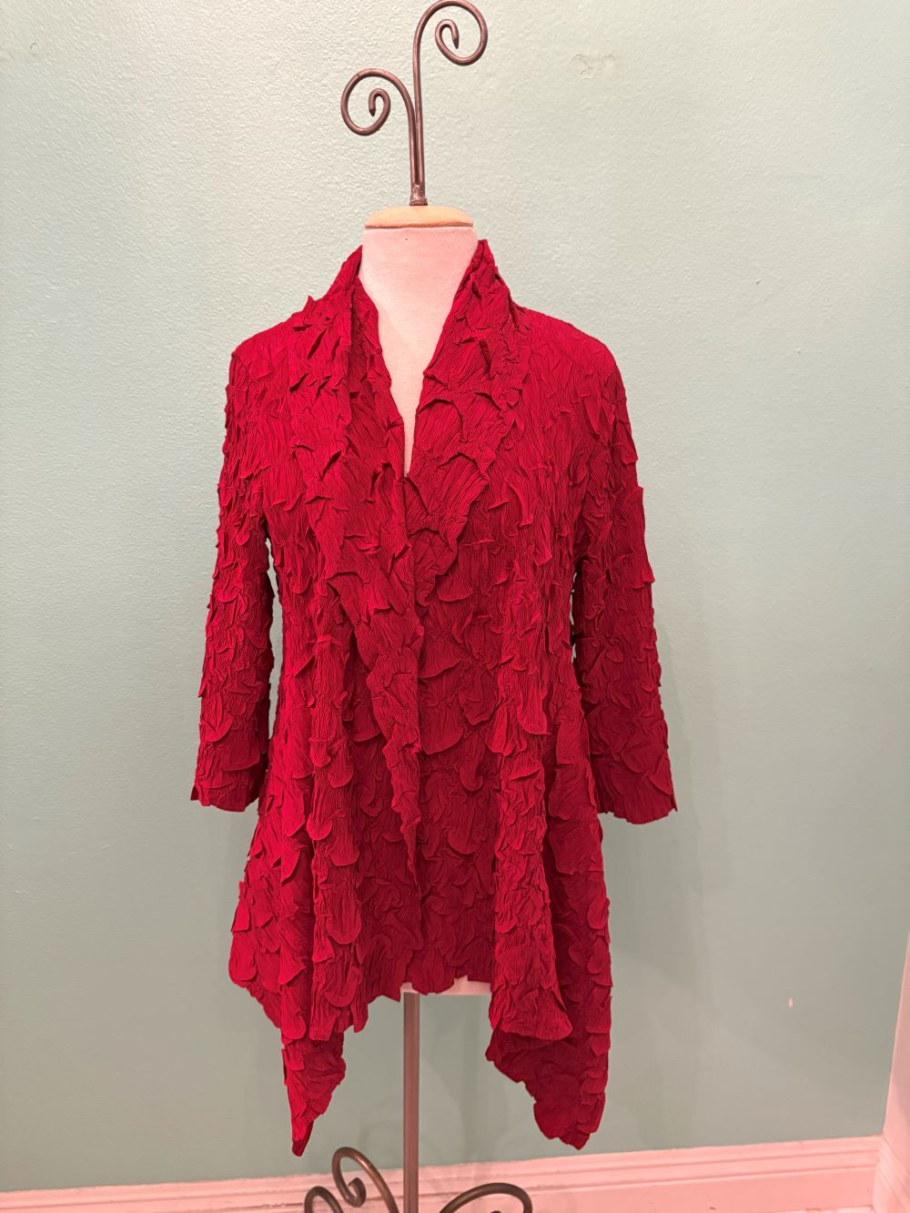 Front view of red crinkle texture waterfall cardigan on mannequin
