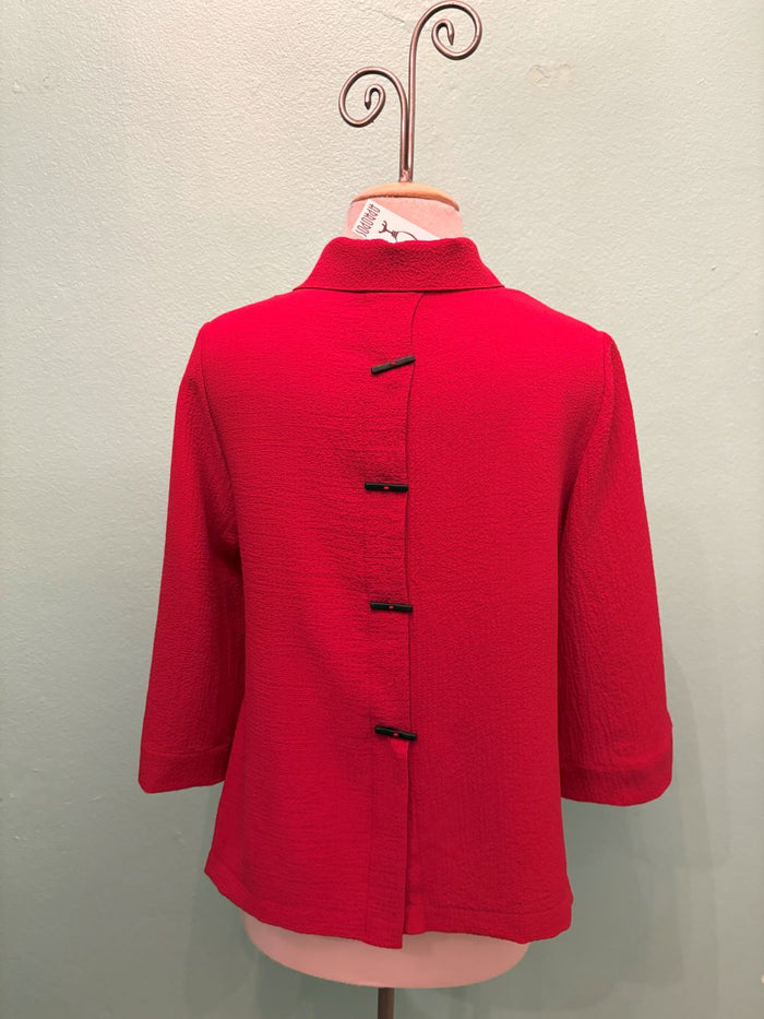 Back view of red textured jacket with unique black accented back buttons