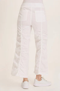 Back view showing pocket details and ruched design on white wide leg pants