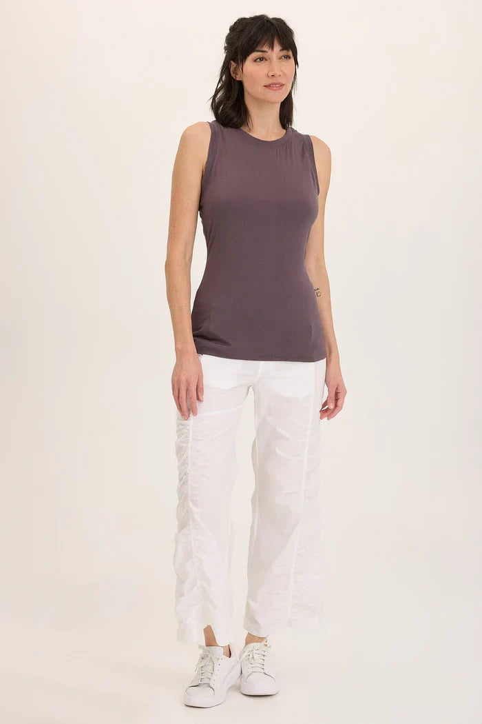 Front view of model wearing ruched white wide leg pants with a sleeveless top