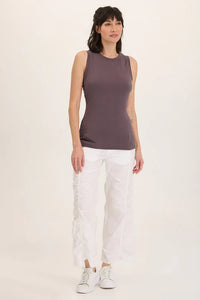 Front view of model wearing ruched white wide leg pants with a sleeveless top