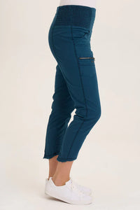Side view of teal utility capri pants featuring zip pocket and frayed hem