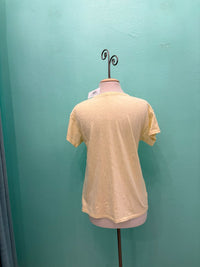 Back view of a soft yellow relaxed fit t-shirt displayed on mannequin