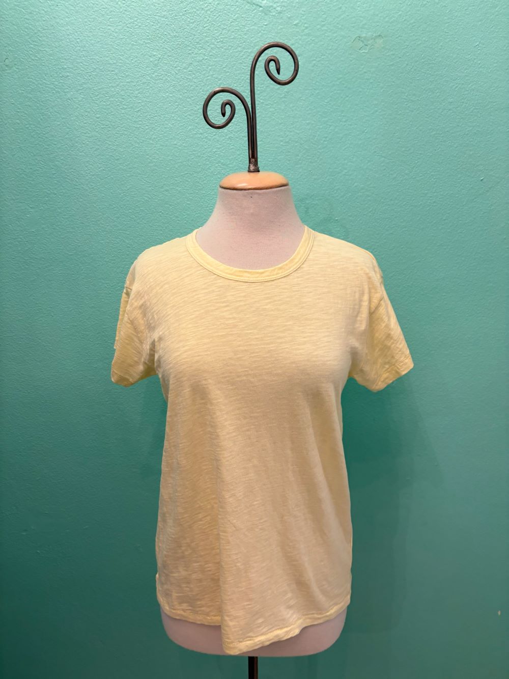 Front view of a soft yellow relaxed fit t-shirt displayed on mannequin