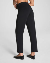 Back view of black stretch tapered pants displaying streamlined silhouette