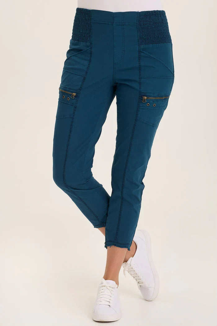 Front view of teal utility capri pants with dual zip pockets and contrast seams