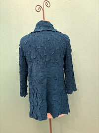 Back view of textured blue crinkle waterfall cardigan on mannequin
