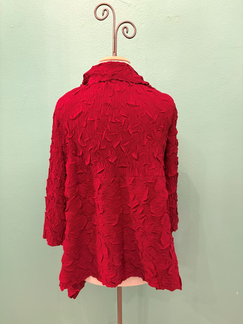 Close-up displaying rich red crinkle textured fabric and collar details