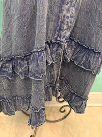 Tiered ruffle hem detail on a crinkled indigo bohemian dress
