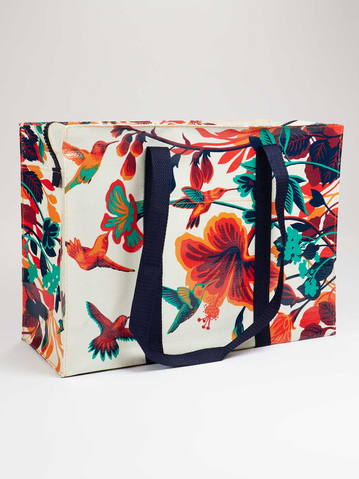 Large tote bag with tropical flower and hummingbird design and sturdy navy handles