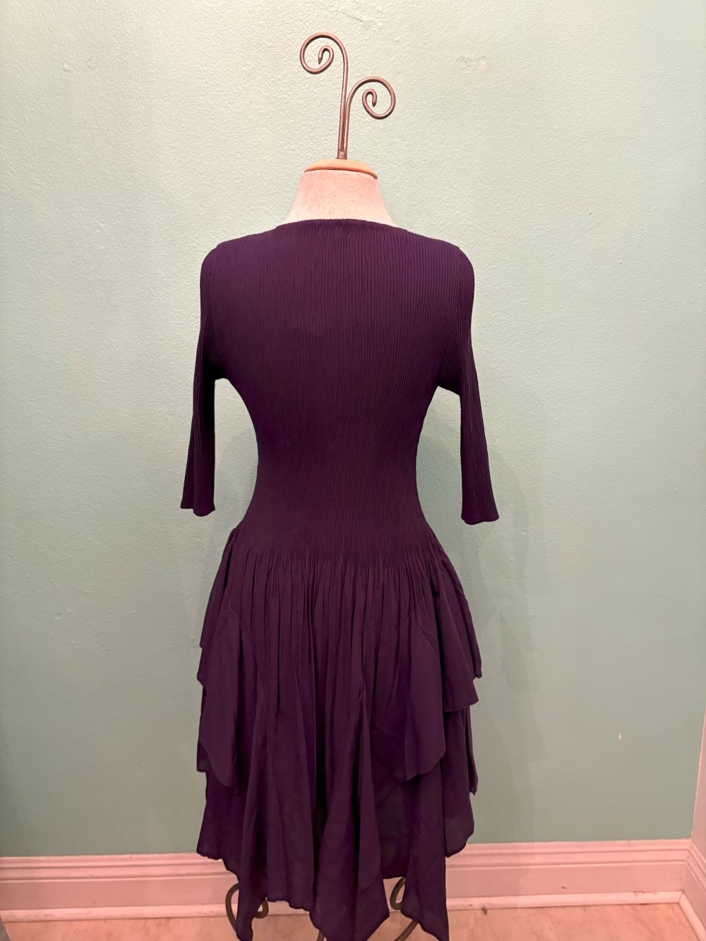 Back view of the Twilight Ruffle Midi Dress in deep purple with tiered hem