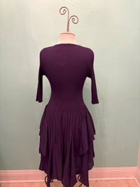 Back view of the Twilight Ruffle Midi Dress in deep purple with tiered hem