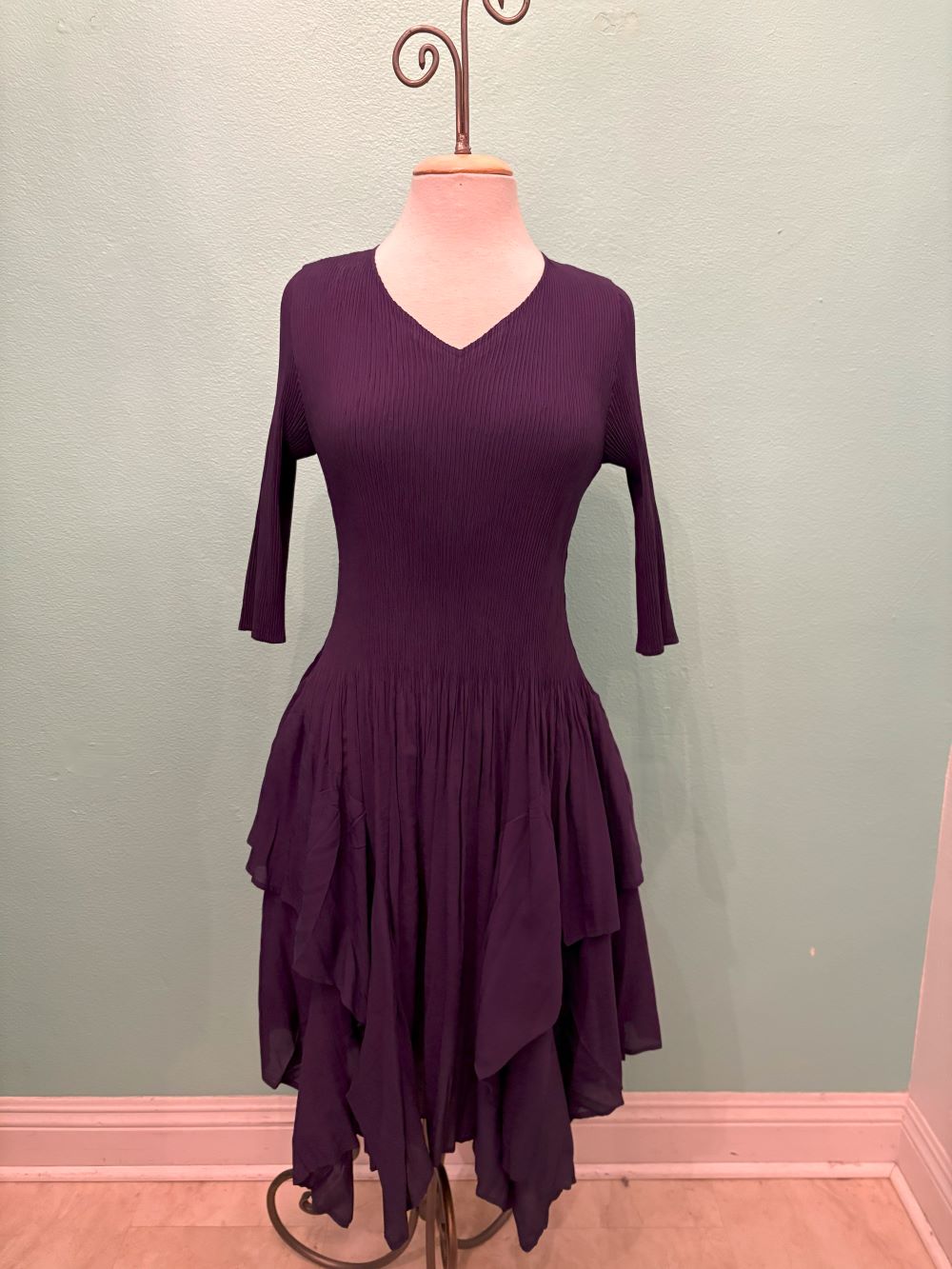 Front view of the Twilight Ruffle Midi Dress in deep purple featuring a v-neckline and ruffled layers