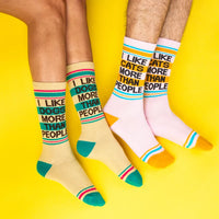 Comparison of two people wearing 'I Like Dogs More Than People' and 'I Like Cats More Than People' socks