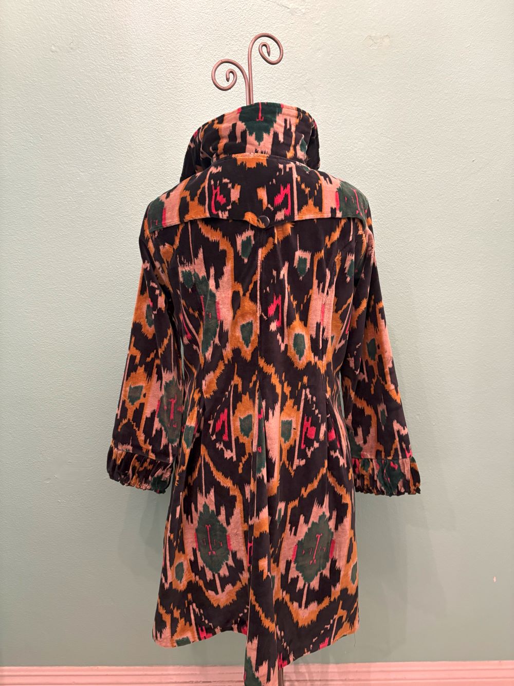 Full back shot of artistic velvet Ikat coat with colorful pattern and gathered sleeves