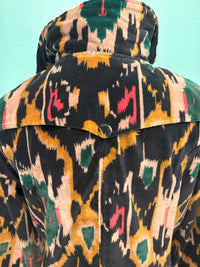 Back view of velvet coat with vibrant Ikat print and high collar