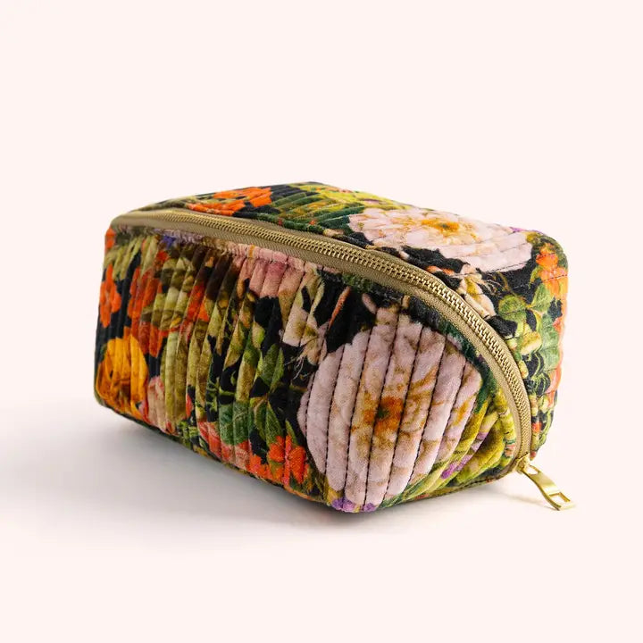 Plush velvet cosmetic bag with vibrant floral pattern and gold zipper