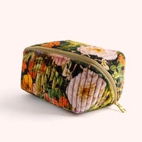 Plush velvet cosmetic bag with vibrant floral pattern and gold zipper