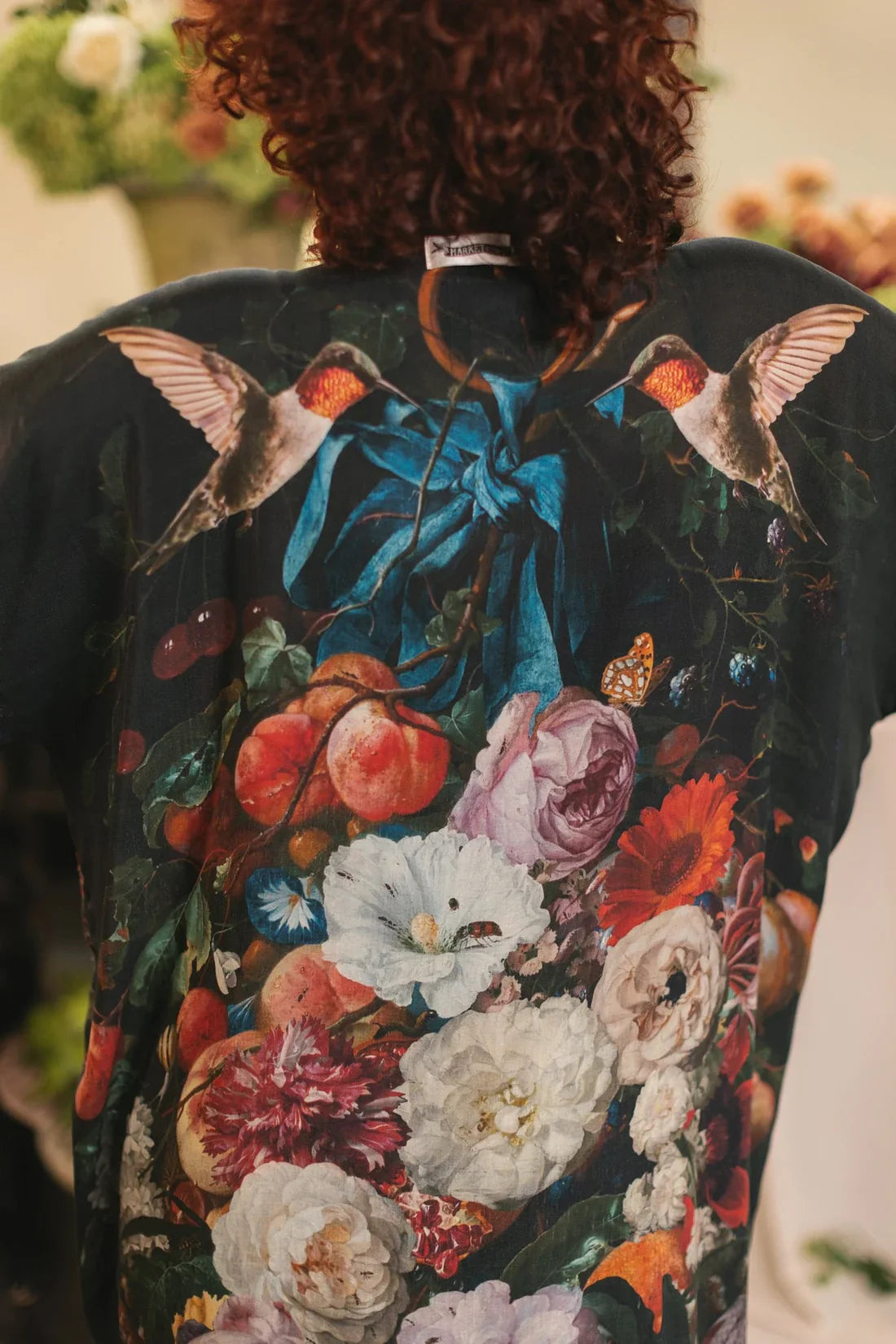 Back view of the kimono robe showing vibrant flowers, foliage, and hummingbirds