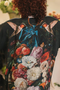 Back view of the kimono robe showing vibrant flowers, foliage, and hummingbirds