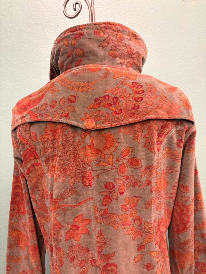 Close-up of vintage-inspired velvet coat with orange floral print and button detail