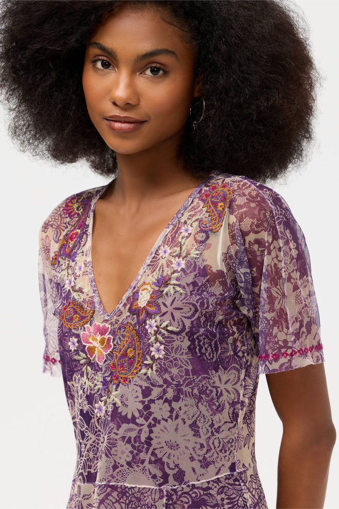Close-up of the embroidered neckline on a violet lace floral dress