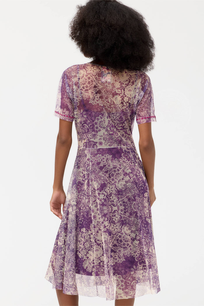 Back view of a woman wearing a violet lace floral midi dress with short sleeves
