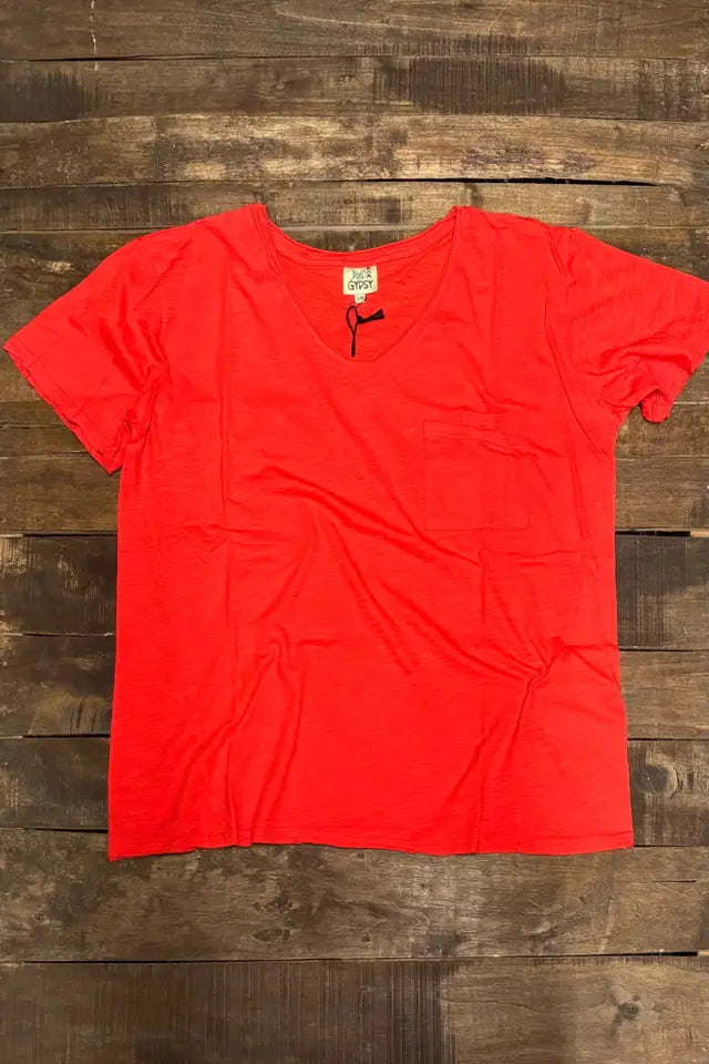 Wild Gypsy red pocket t-shirt laid flat on a rustic wooden background